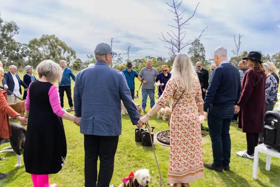 A family honoring their pet by planting a memorial tree with their pet's ashes in Melbourne Australia