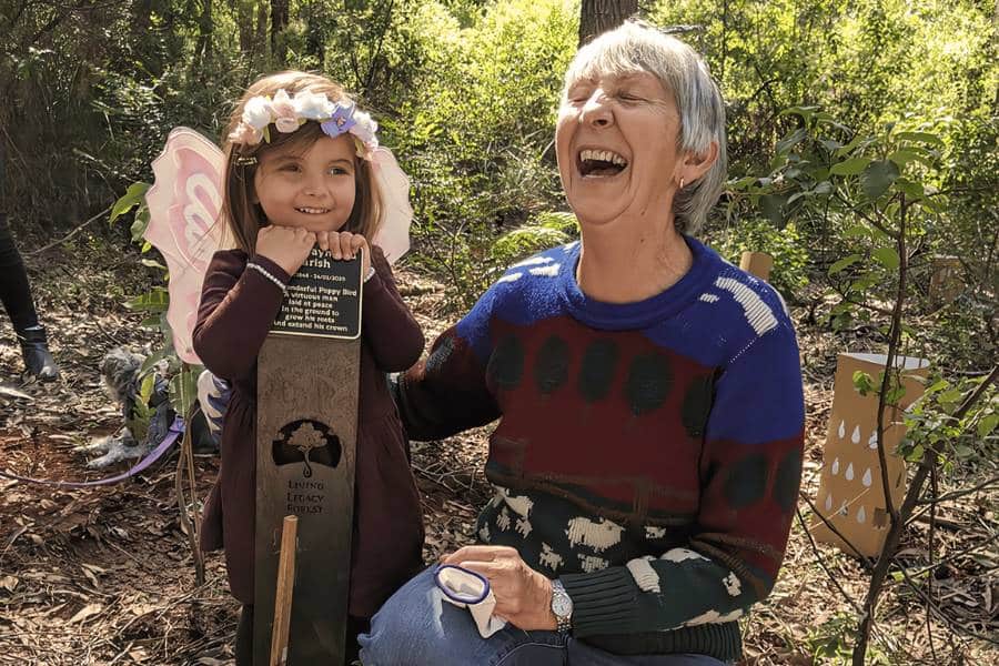 A woman feeling happy after planting a memorial tree in Australia