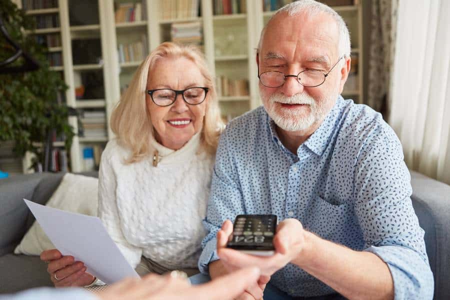 A woman and her husband check the details of funeral cost for pensioners in Australia