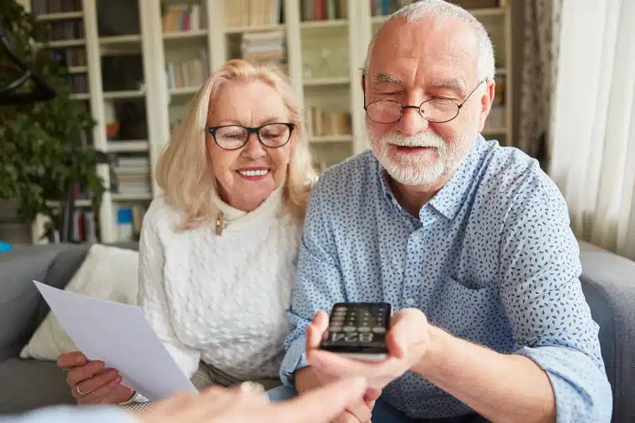 A woman and her husband check the details of funeral cost for pensioners in Australia