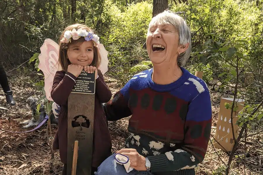 A woman smiling having a fun funeral with Living Legacy Tree at Wellington Dam Living Legacy Forest